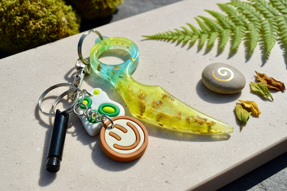 Vibrant gradient resin dagger keychain in elegant setting